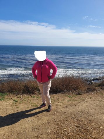 My mother posing in front of the ocean