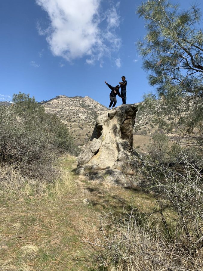 My dad and I posing on top of a rock while camping.
