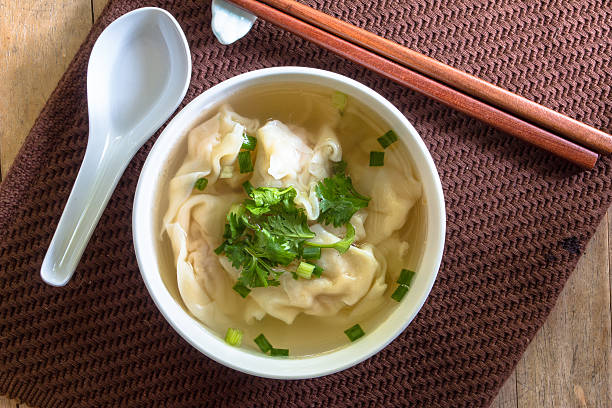 This is wonton soup a Chinese soup that is prepared with wontons, which are small dumpling-like morsels filled with various meats, seafood, or vegetables, a clear broth, and several seasonings