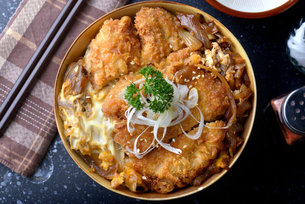 This is Katsudon a common delicacy in Japan, it has onions with eggs mixed in together with a Pork Cutlet and Rice it is very delicious.