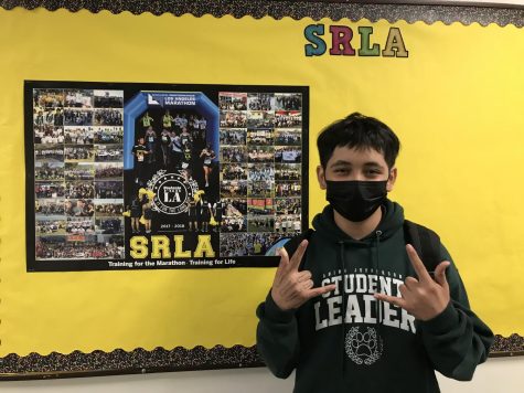 Jeshuah standing in front of the SRLA bulletin board.