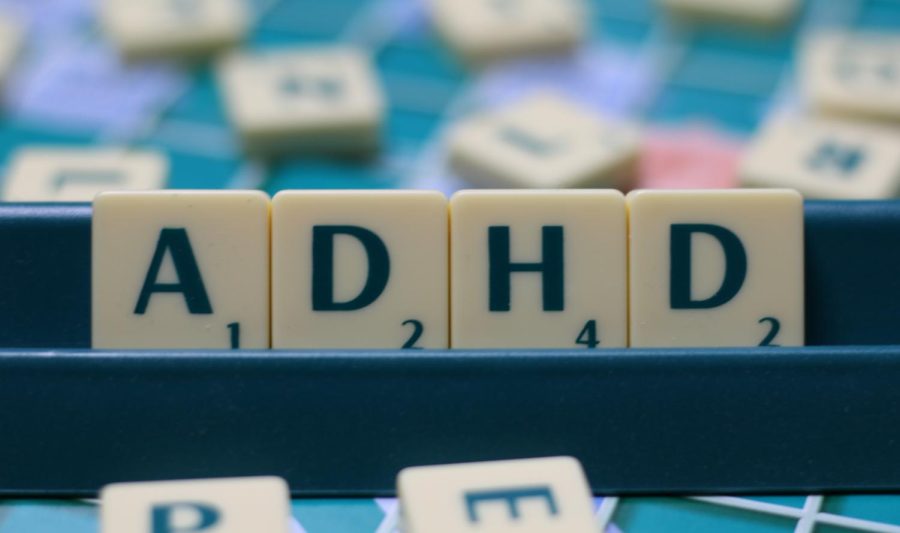 Scrabble tiles spelling out ADHD