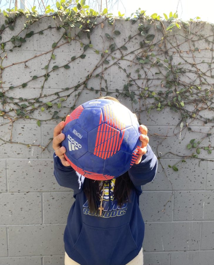 Melane holding a soccer ball.