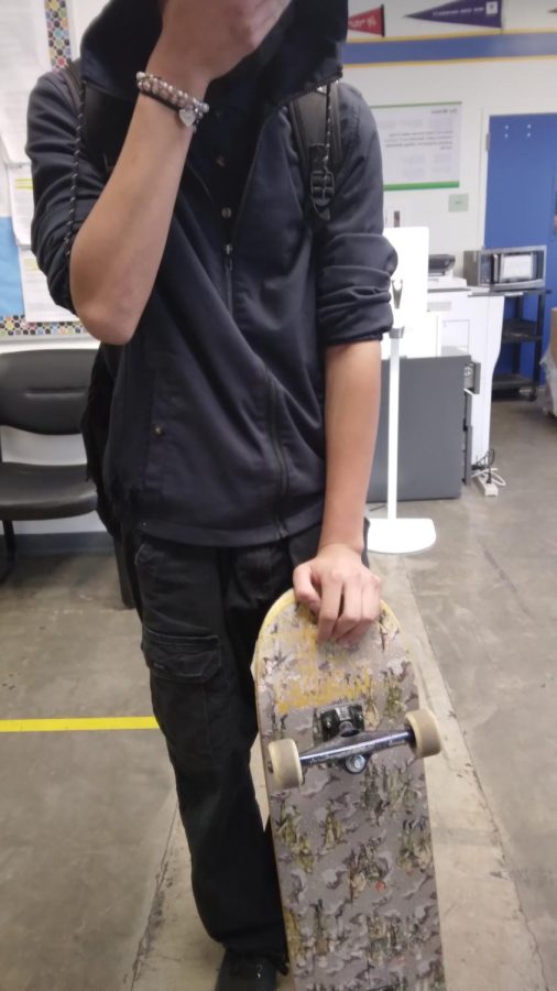 Jeovani with his skateboard.