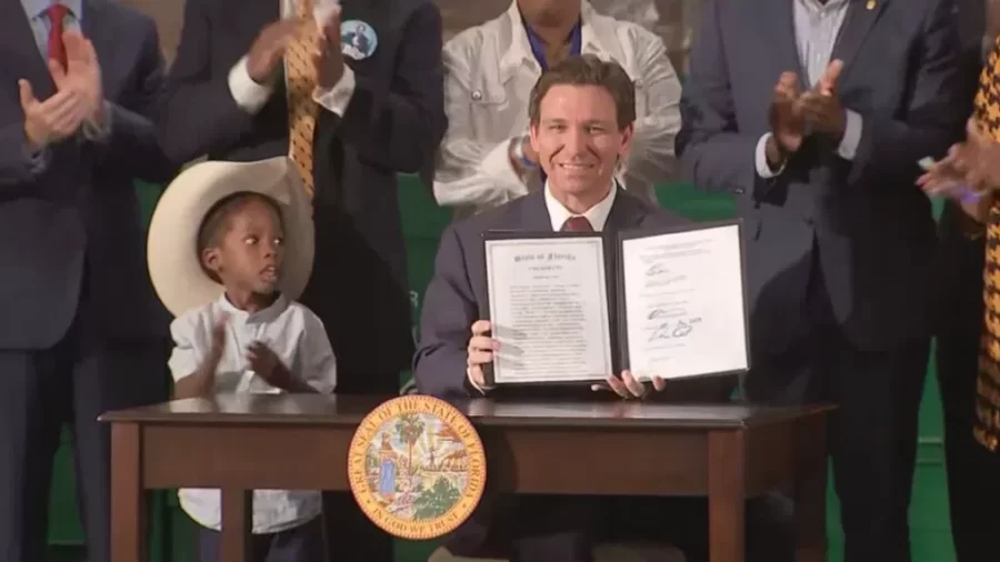 Florida governor Ron Desantis signing a new immigration bill.