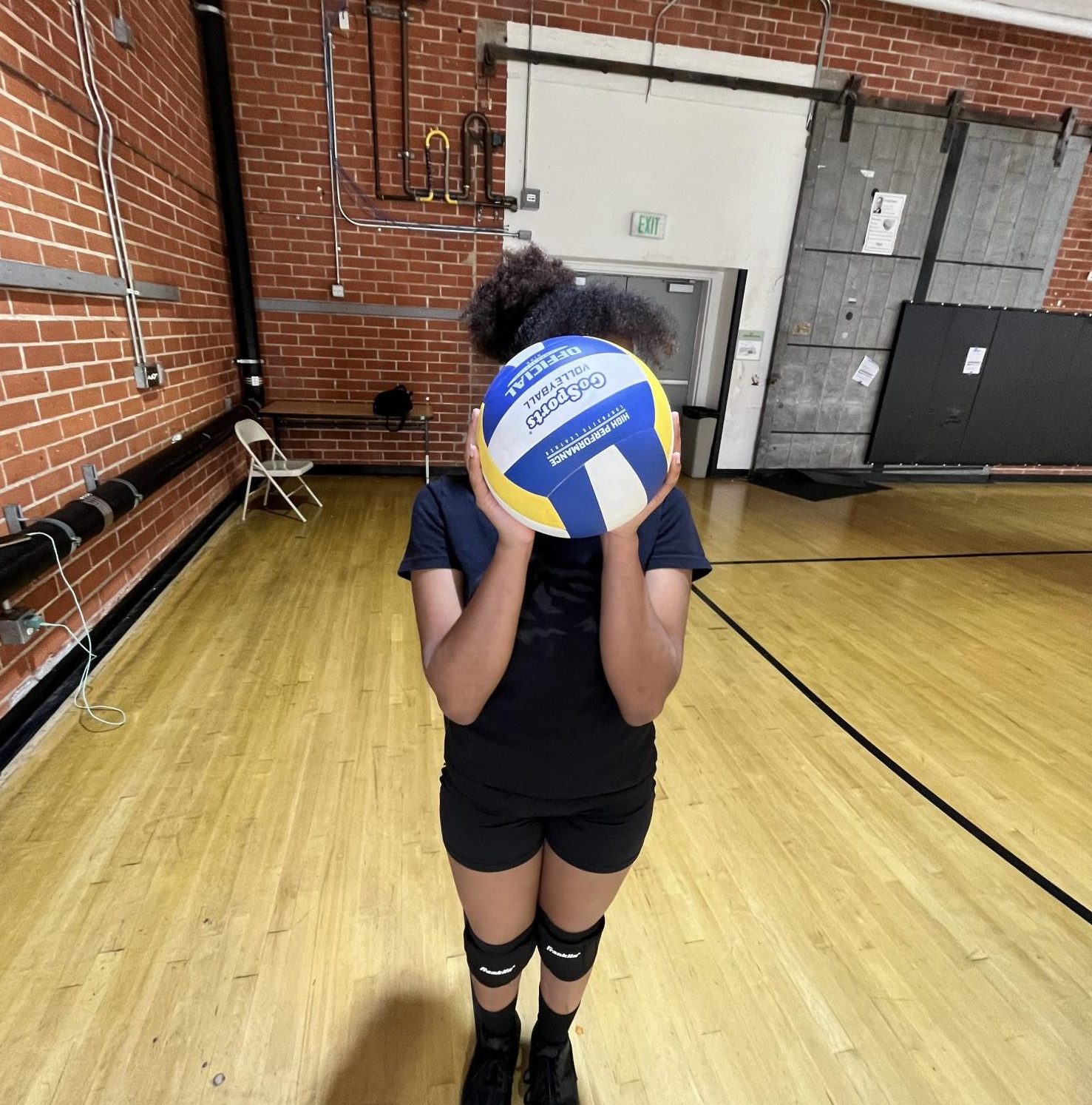 Balushia holding a volleyball. 