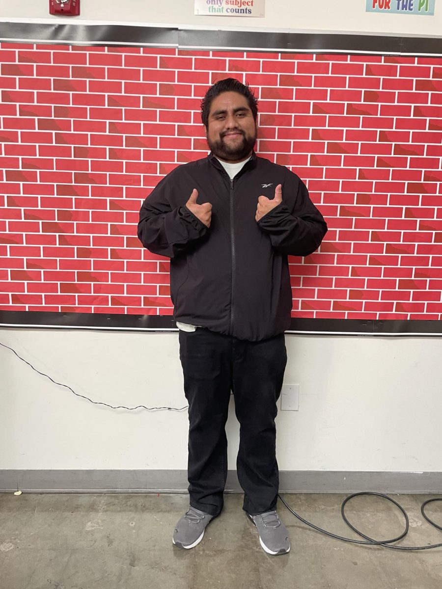 Mr. Diaz is giving a thumbs up because he was extremely happy to take the photo.
