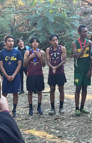 Josue holding his medal at the league cross country meet in Elysian Park.