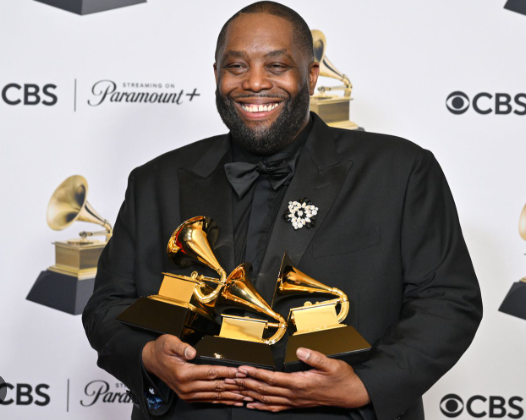 Killer Mike holding all three of his Grammys.  