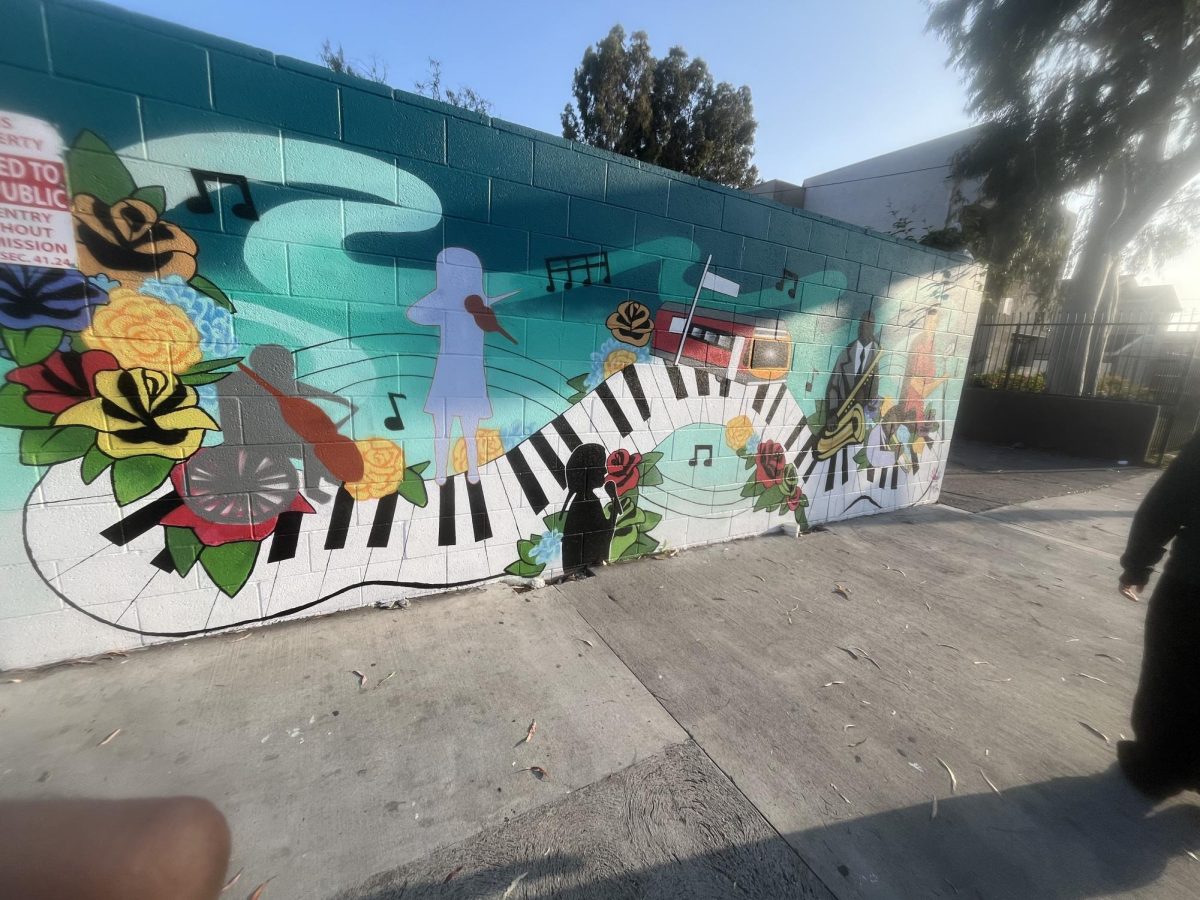 Outside of a Los Angeles City Council member's office there is more music-themed art which shows a piano and artist with a violin.
