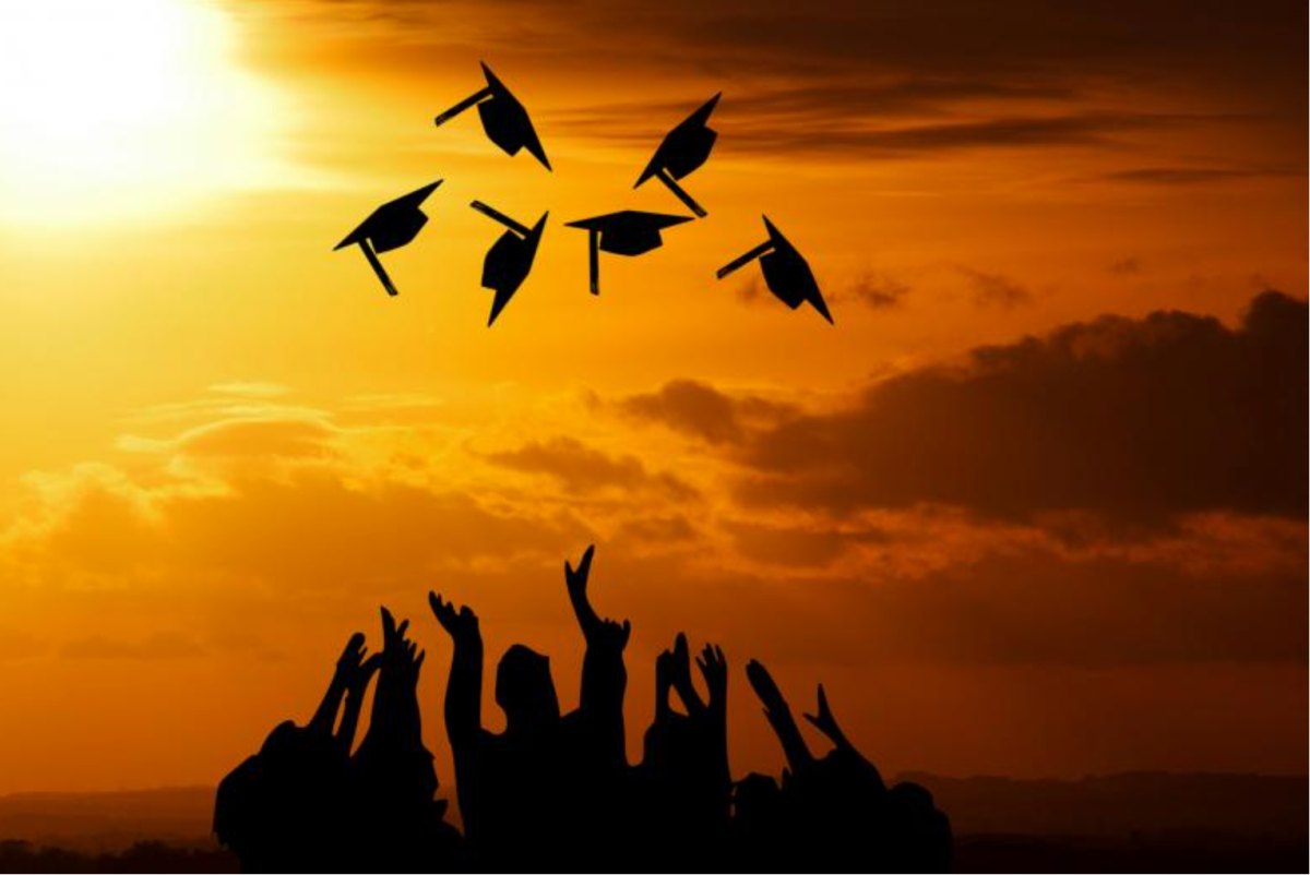 Graduates throwing their caps in the air. 