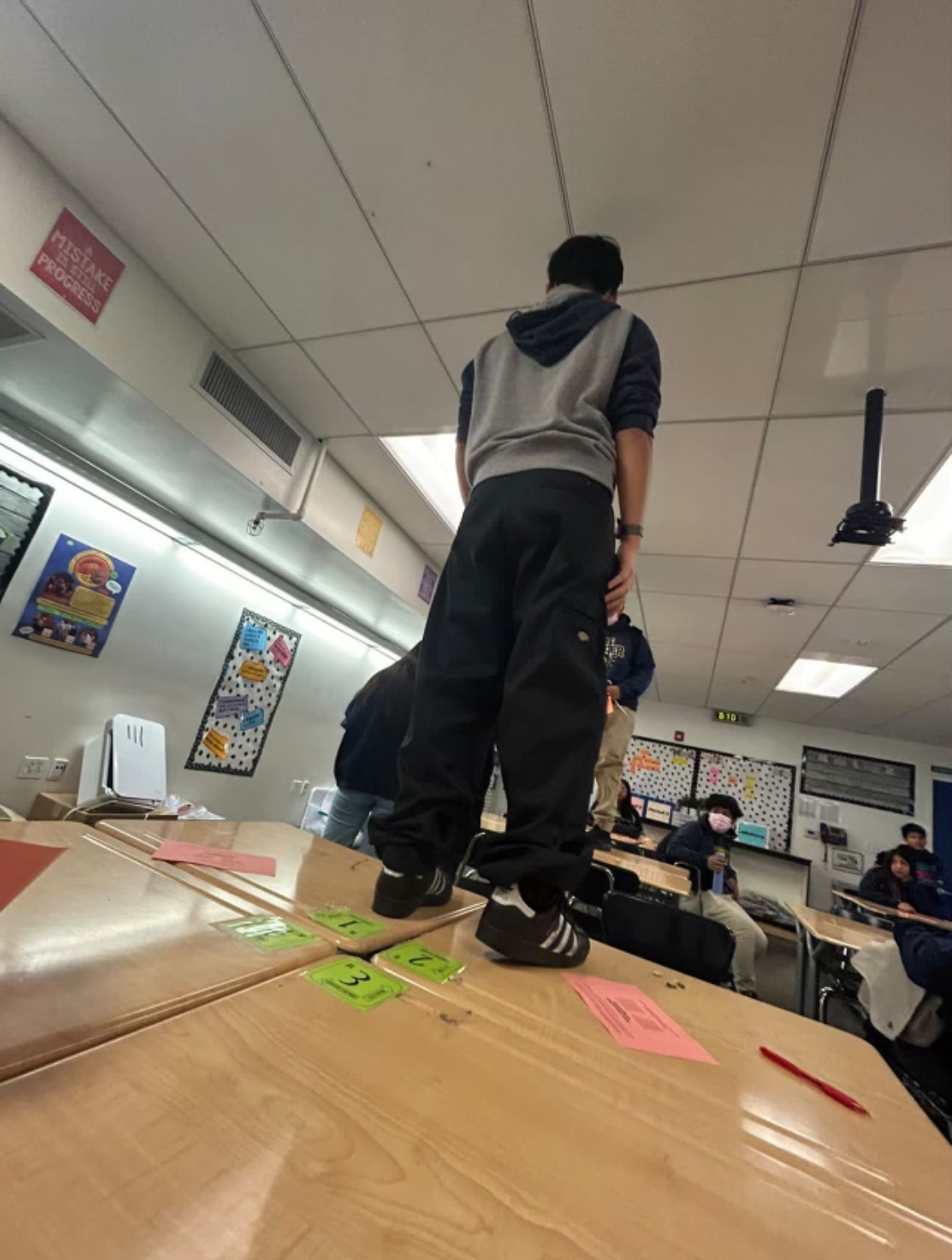 Alexis standing on a table in Ms. Brede's room.