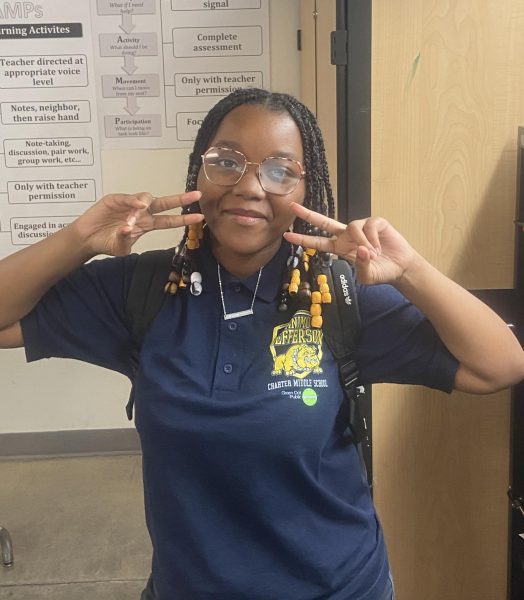 Jay'Onna Moore making the peace sign in Mr. Finer's classroom.