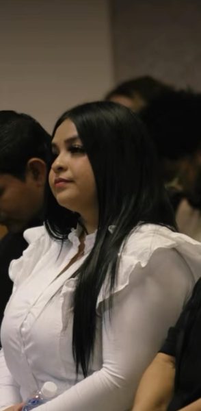 Medina Lisa is paying attention to the preaching at "Open Heavens Church."