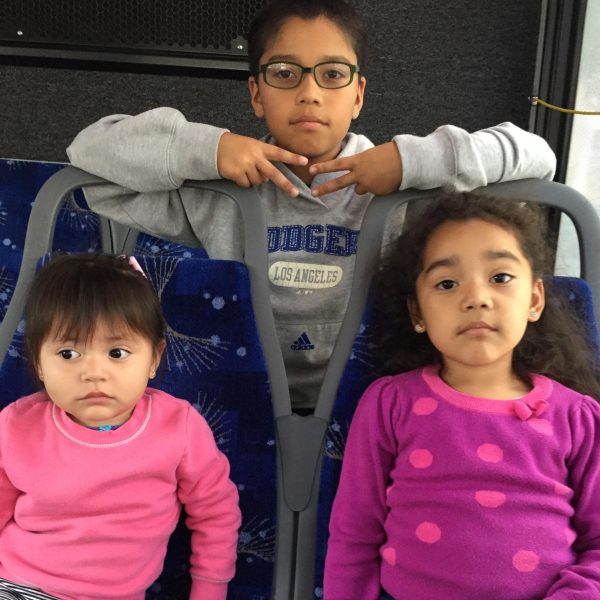 Melisa, her brother Daniel, and her cousin Bella on the bus to downtown. 