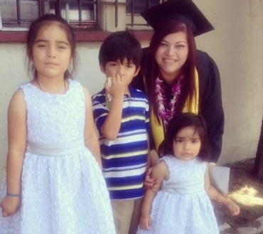 Ms. Ramirez, after graduating, with her kids and smiling. 