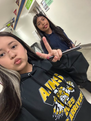 Candy and Paulette talking a picture in the halls.