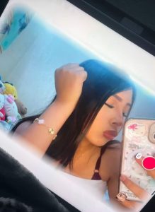 Angie taking a picture/selfie of herself.