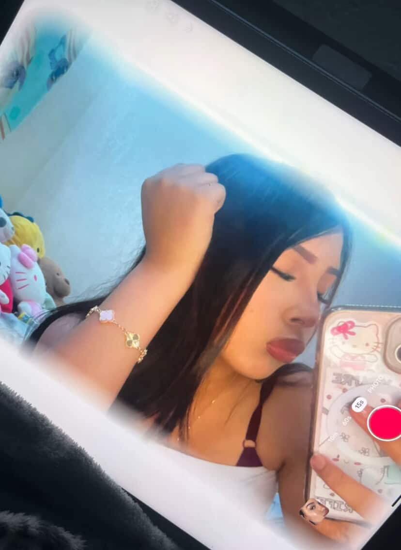 Angie taking a picture/selfie of herself.