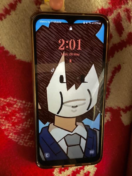 Melanie’s lock screen (me): Character (Amy Lee/Park) from a book I have read lots of times with the munching face meme!