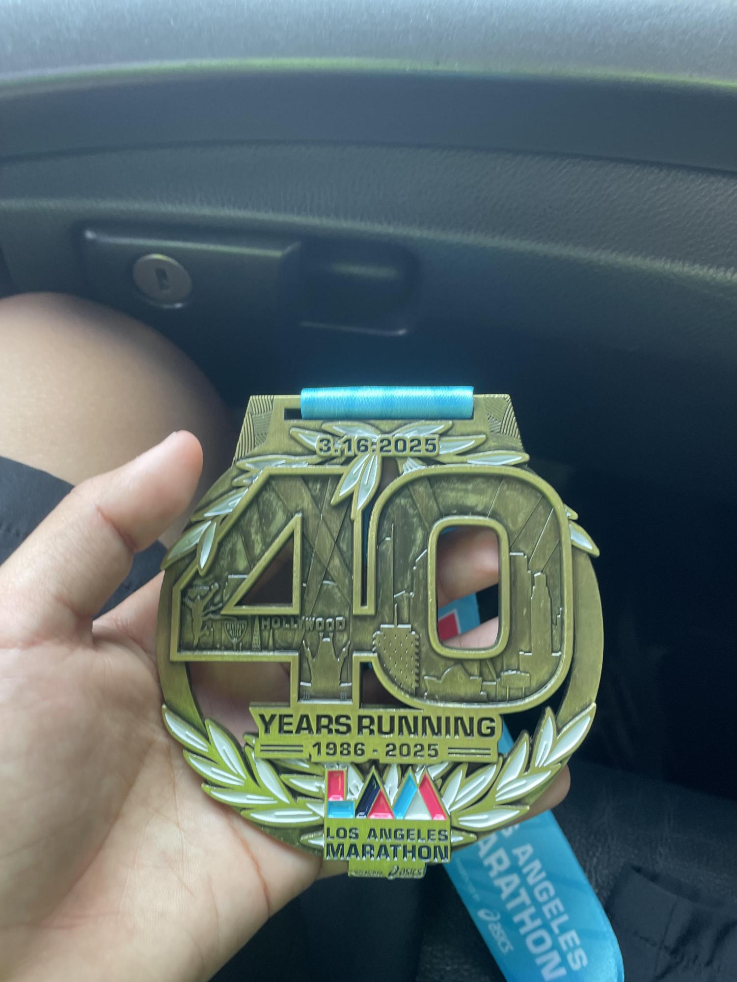 The medal Ethan won after completing a marathon.