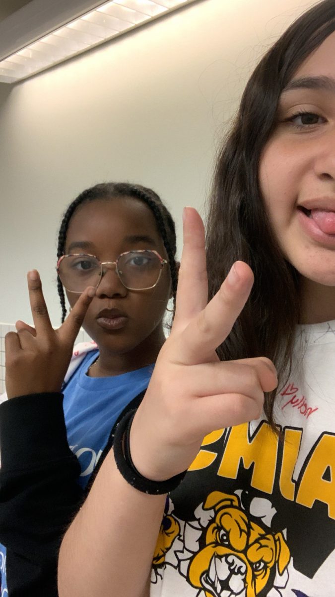 Xathzire and Jay'Onna taking a picture in the bathroom. 