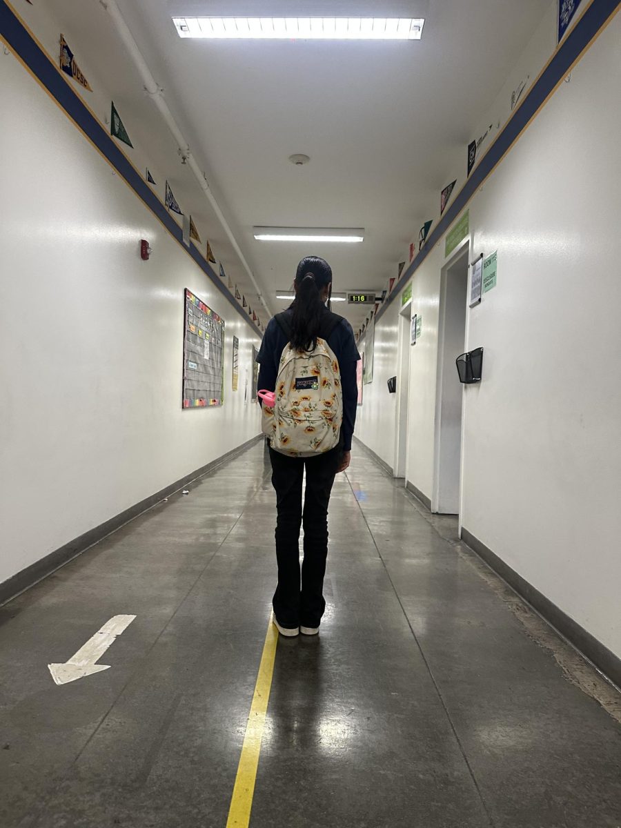Itzia Piedras standing  in the middle of the hallway for a picture.