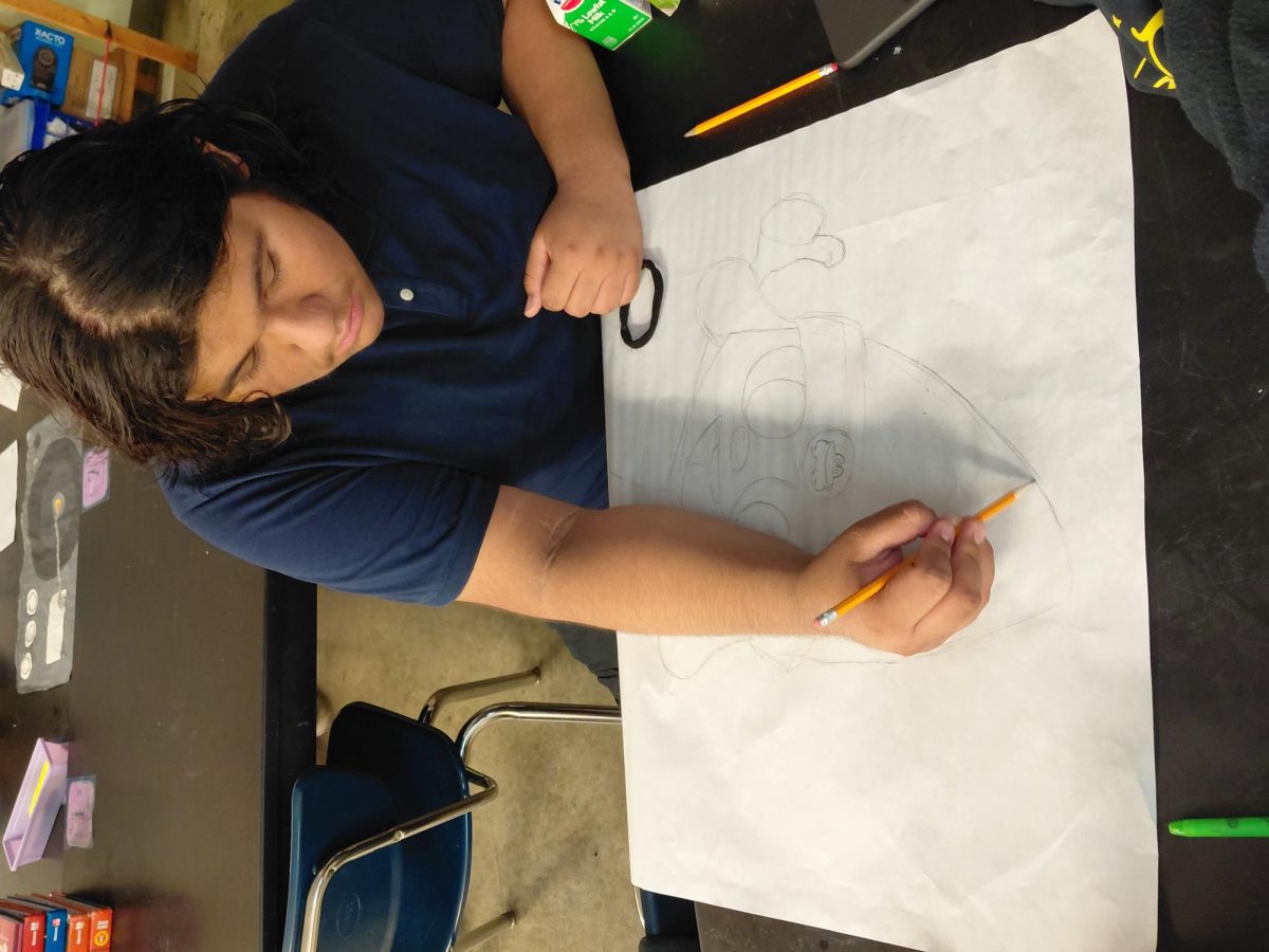 Aaron is working on a poster during advisory for Student Council