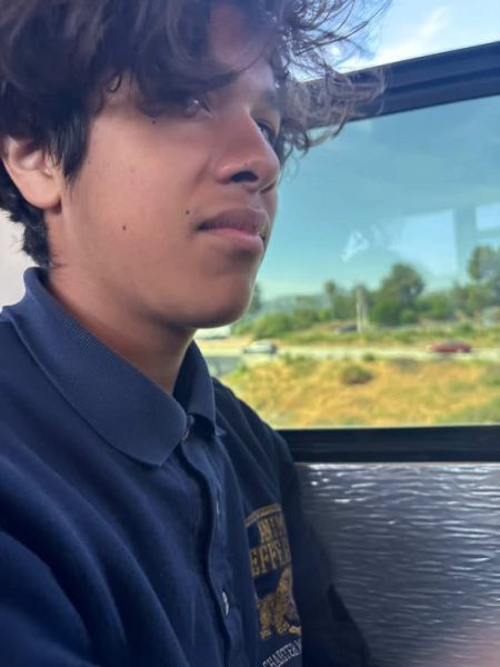 Giancarlo looks outside the window on a bus. He was going on a field trip in seventh grade to see a play.