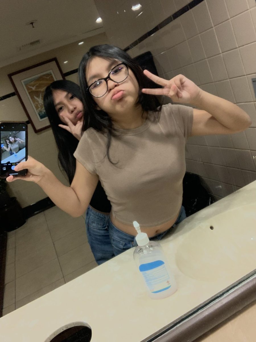 Kimberly Juarez and Daniela Ramirez take pictures at a restaurant while hanging out. 