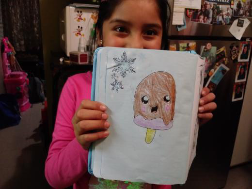 Sarai when she was younger showing a drawing she did.  She used to draw a lot because her second grade teacher she would always make her draw everyday.