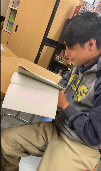 Jeffrey reading Harry Potter in Mr. Finer's class.