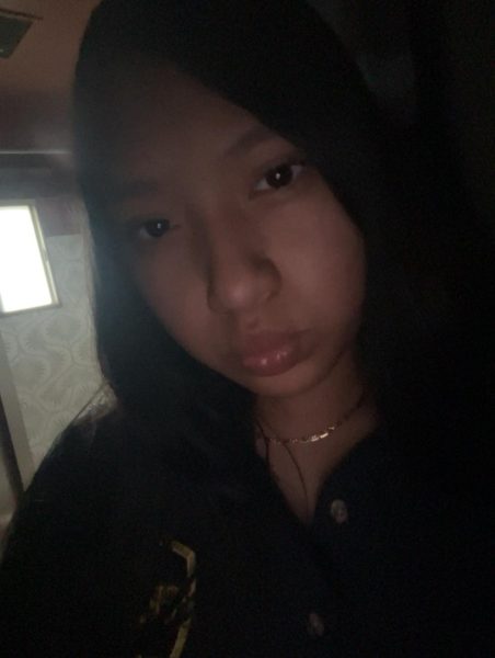 Maria takes a selfie in her school uniform.