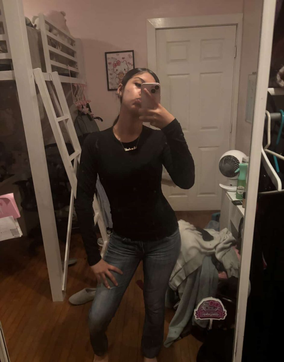 gabby is taking a picture infront of a mirror