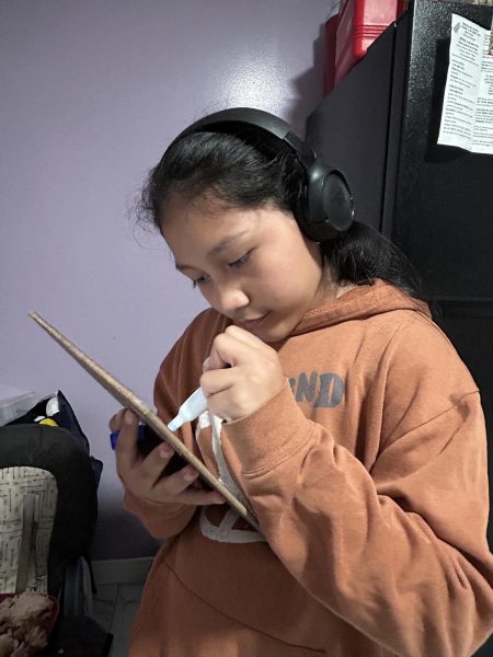 Angelina Mateo draws on her board since she really loves to draw.