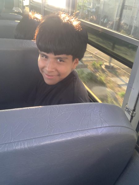 Omar comes back from a school soccer game.