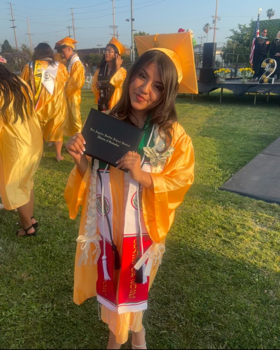Keily walks the stage at graduation at Santee Education Complex.