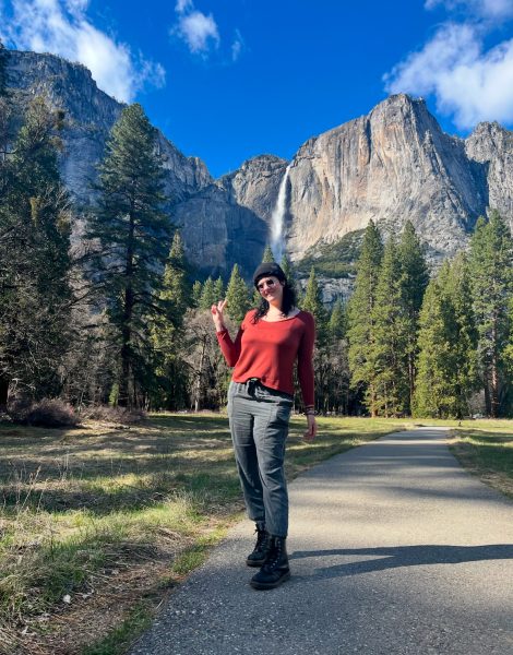 Miss Thomas poses in front of mountains. She was on a trip with her girlfriend. 