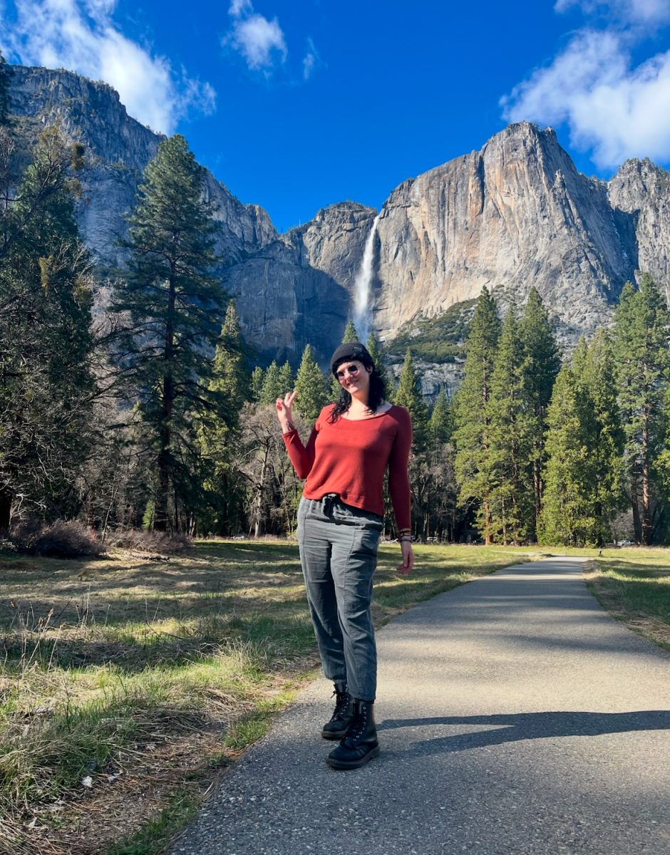Miss Thomas poses in front of mountains. She was on a trip with her girlfriend. 