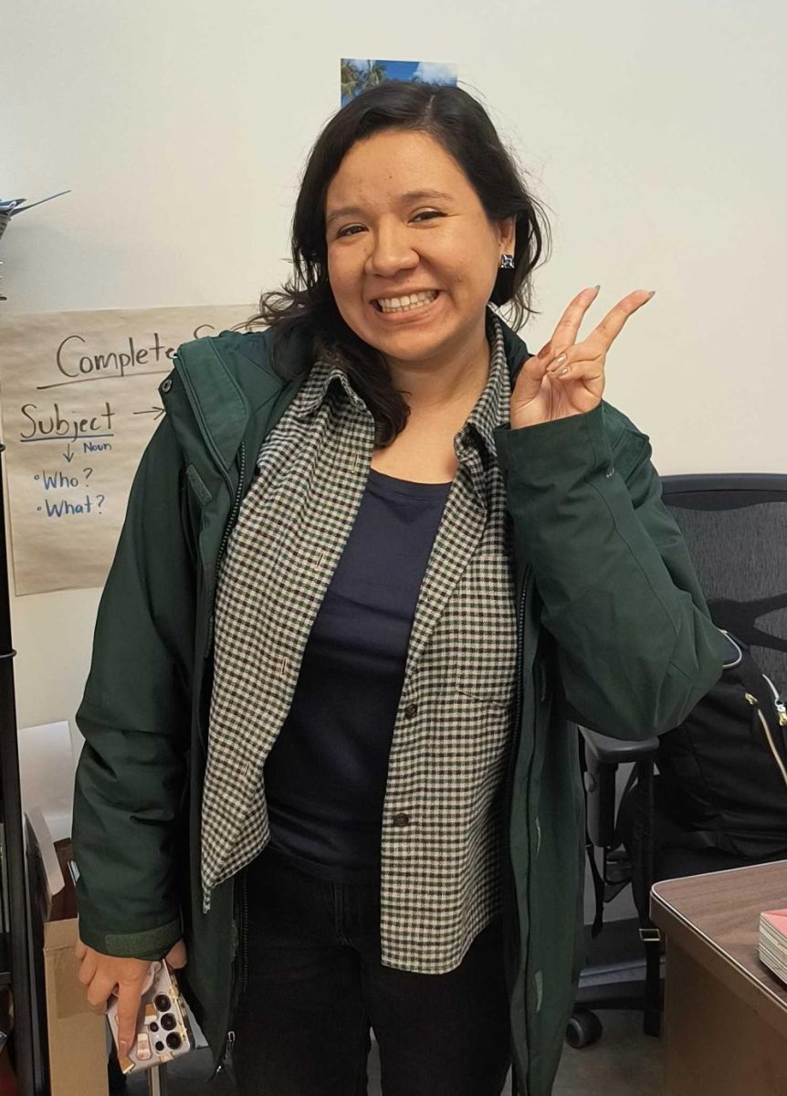 Ms.Briseño poses for a photo after school in her classroom.