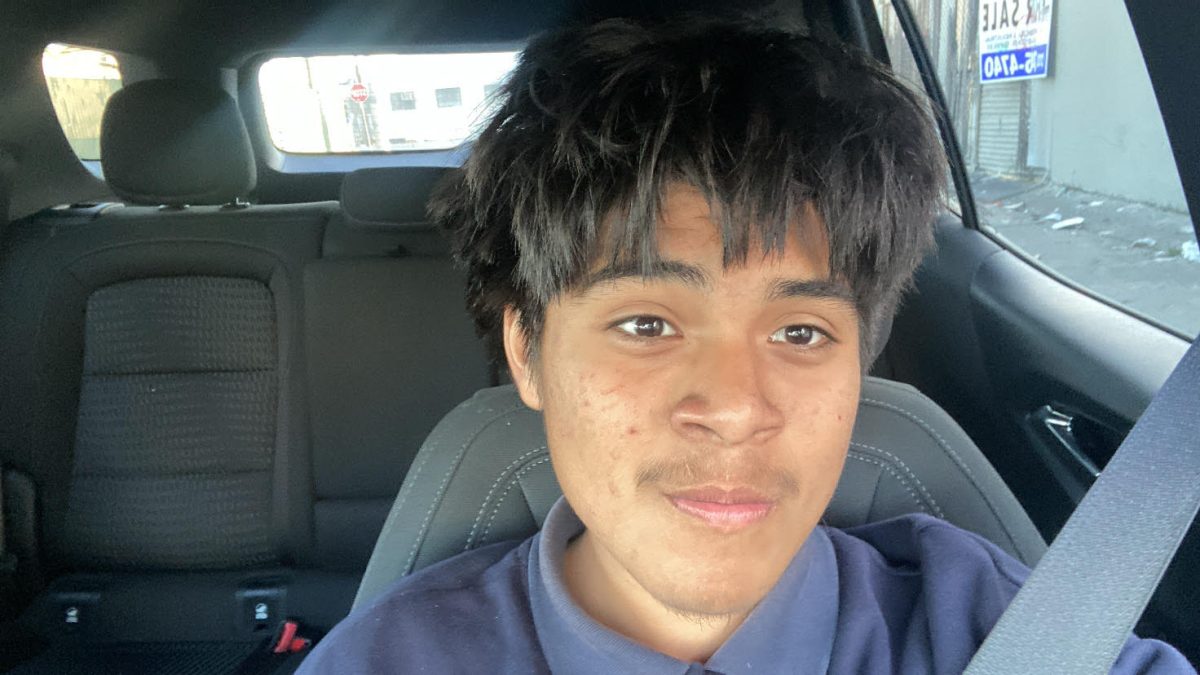 Larry takes a selfie inside of his sister's car.