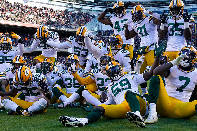 Packers players celebrating taking a photo.