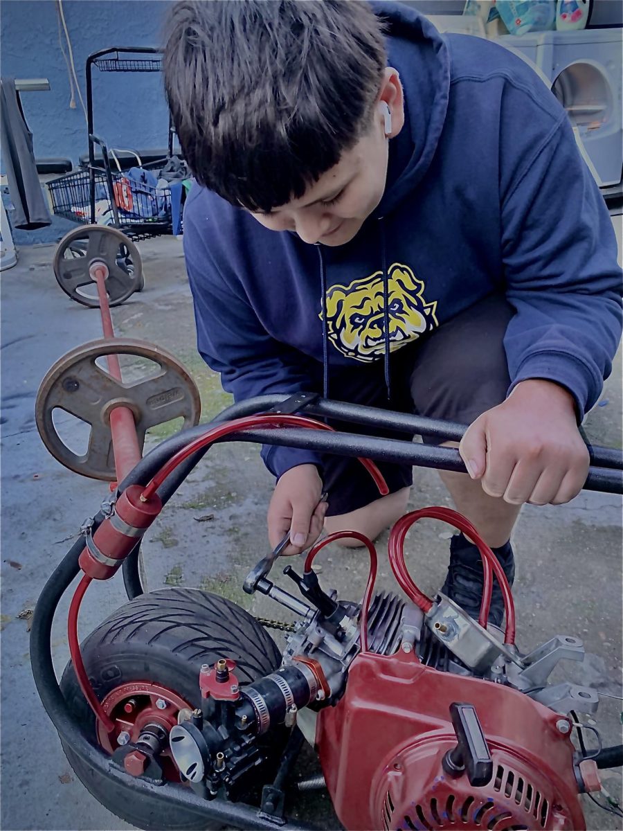 Gerardo works on a mini bike with his cousin after school. 