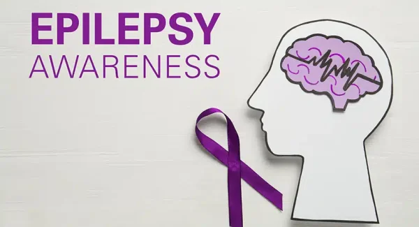 This image shows a purple ribbon with a person and their brain to show awareness about epilepsy.