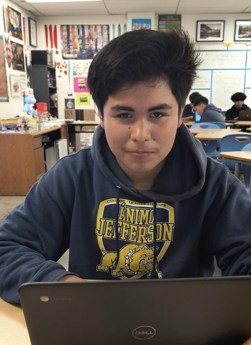 Abraham Marcellez doing work for his story on a Chromebook.
