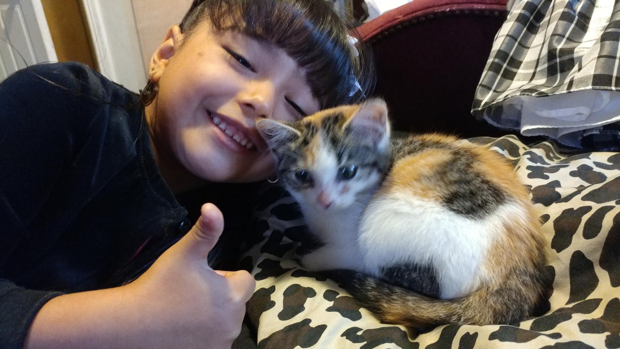 Angelina grooms her cat when she was seven years old.