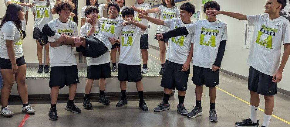 SRLA team carrying Christian Fuentes and pointing at him.