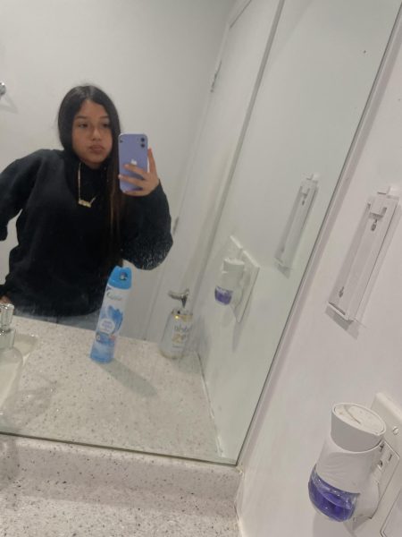 Jasmine taking a selfie in the restroom mirror.