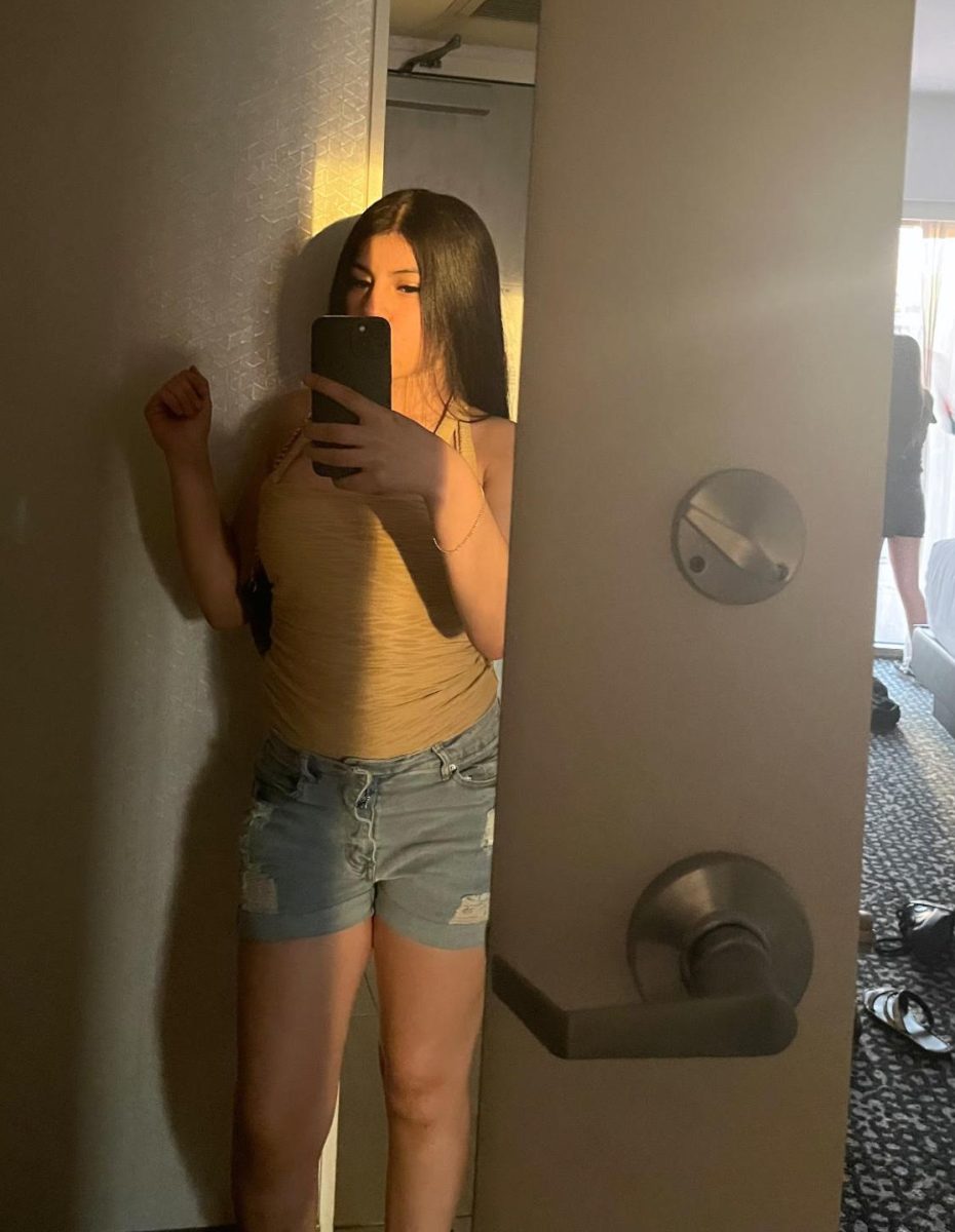 Samantha taking a photo of her self at home.