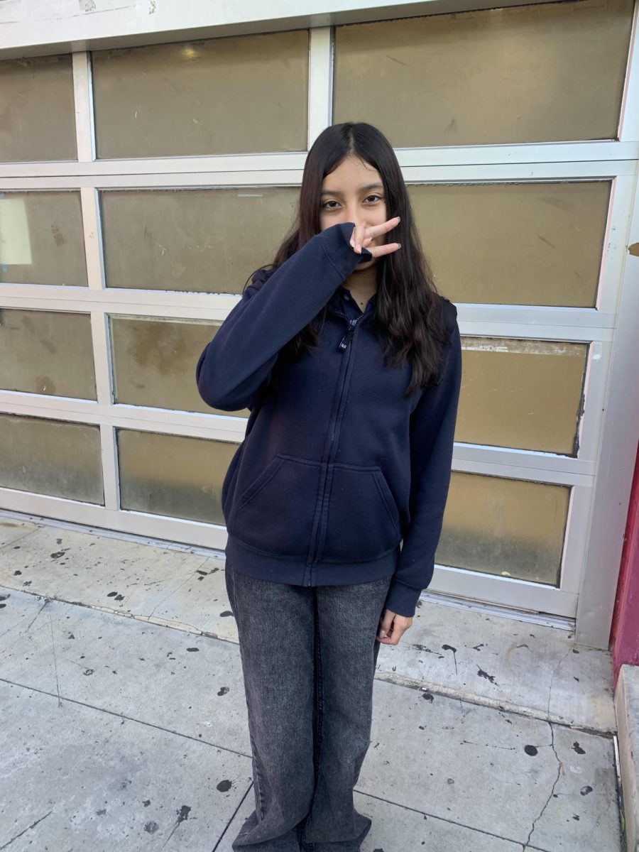 Sarai Ronquillo posing for picture in front of Animo Ralph Bunche's gym.